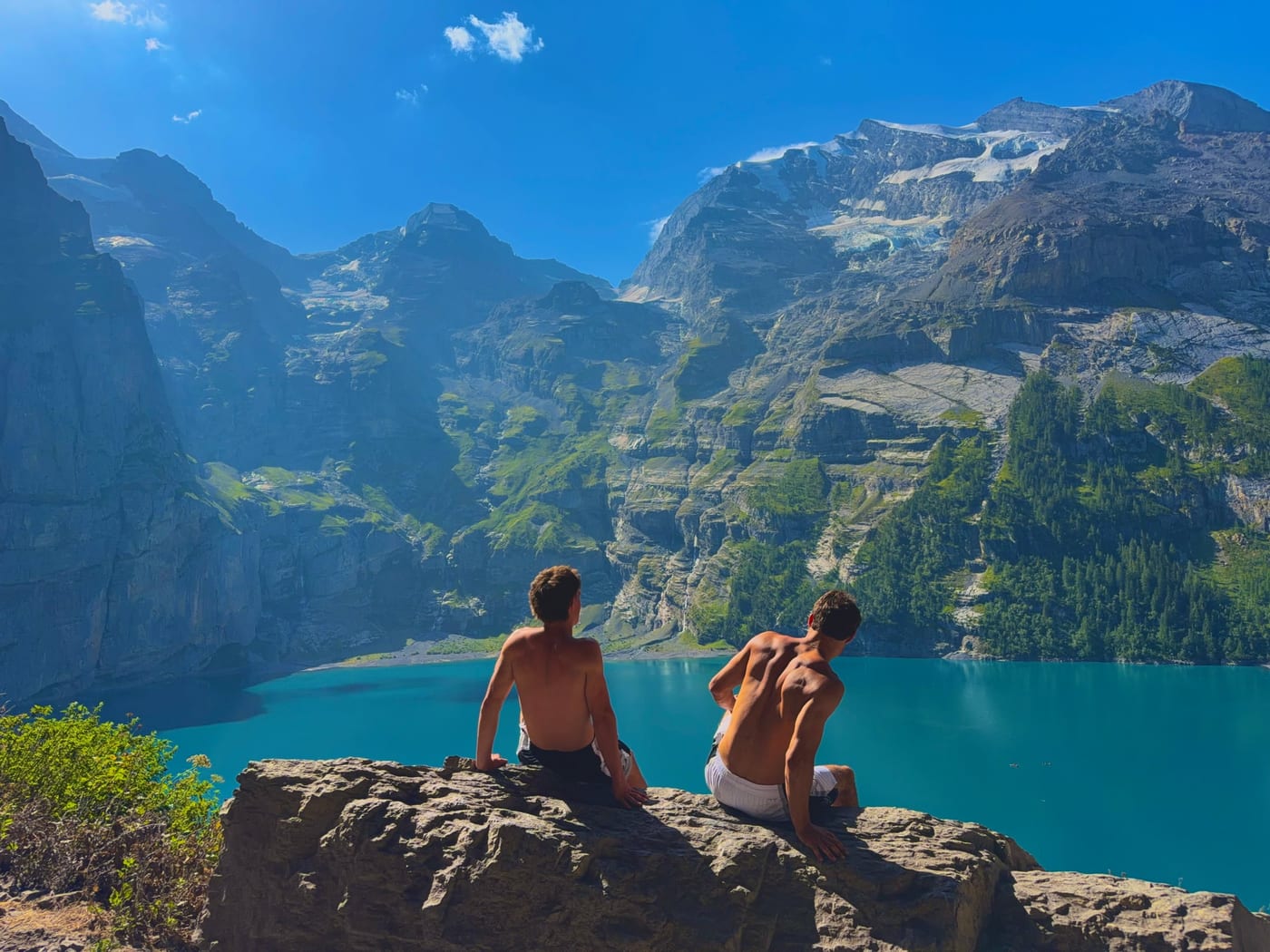 Les deux fondateurs de Cocorio, de dos, face à un lac de montagne.